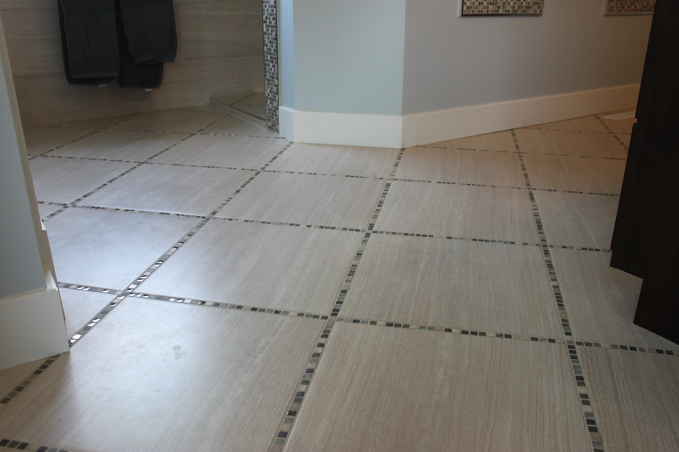 Example of a large transitional master gray tile and porcelain tile porcelain tile doorless shower design with dark wood cabinets and blue walls