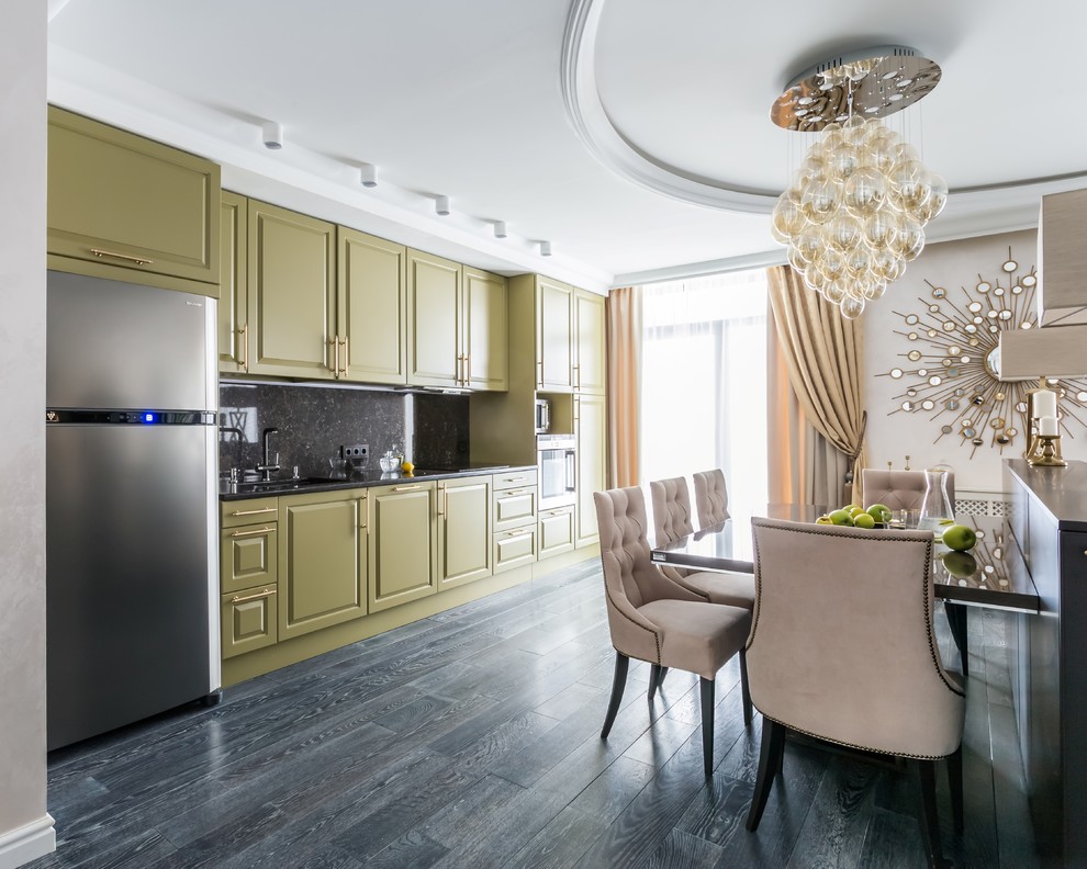 Design ideas for a mid-sized transitional single-wall open plan kitchen in Saint Petersburg with an undermount sink, raised-panel cabinets, green cabinets, black splashback, quartz benchtops, stone slab splashback, stainless steel appliances, painted wood floors and no island.