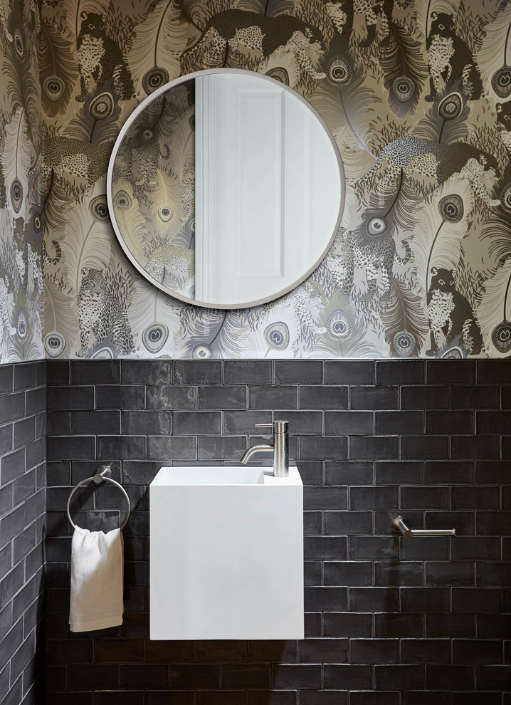 Photo of a contemporary powder room in Melbourne with gray tile, subway tile, multi-coloured walls and a wall-mount sink.