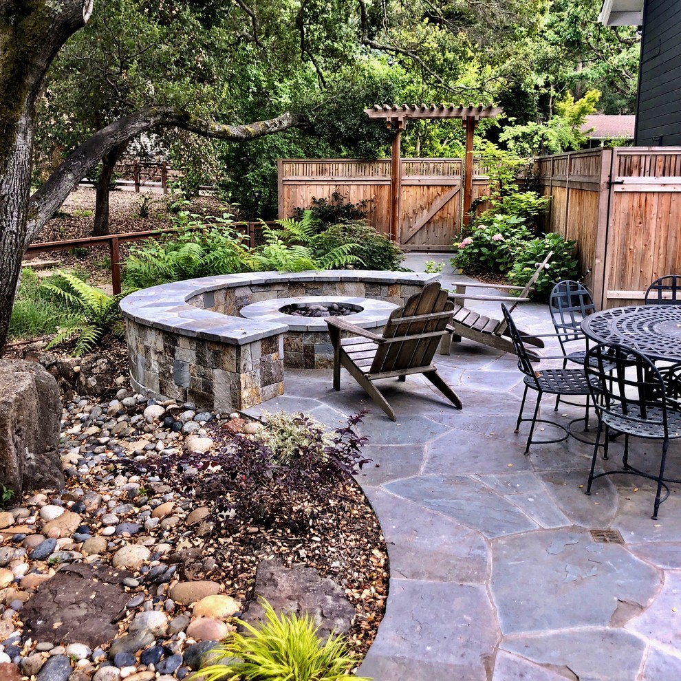 Inspiration for a mid-sized traditional front yard patio in San Francisco with a fire feature, natural stone pavers and a gazebo/cabana.