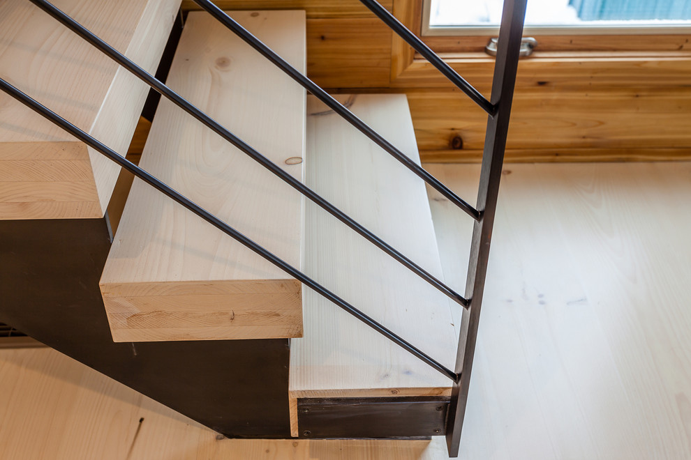 Photo of a mid-sized contemporary wood straight staircase in New York with open risers.