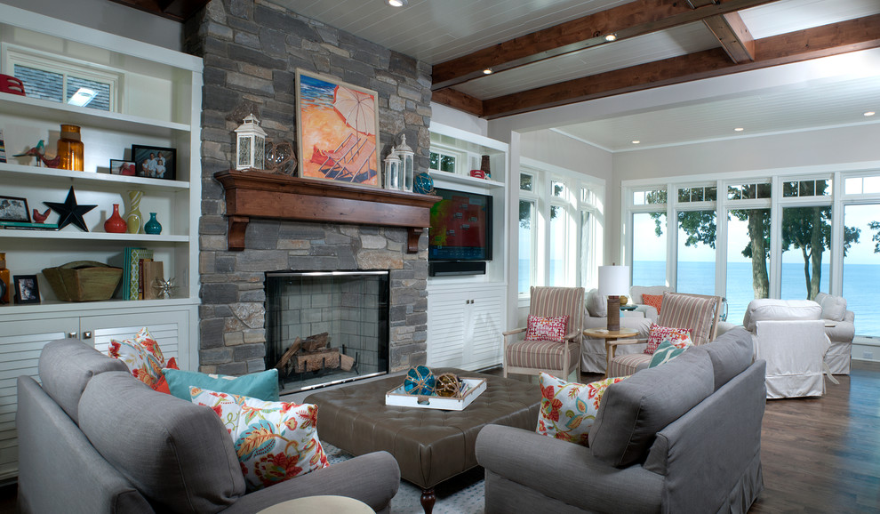 Design ideas for a beach style formal open concept living room in Grand Rapids with grey walls, dark hardwood floors, a standard fireplace, a tile fireplace surround and a wall-mounted tv.