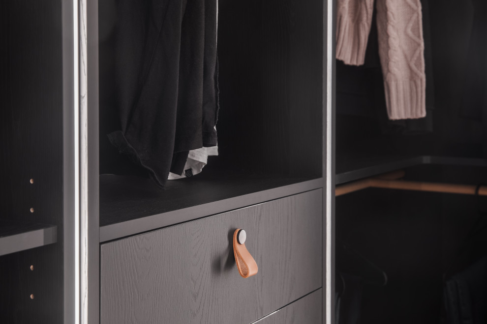 This is an example of a medium sized contemporary gender neutral walk-in wardrobe in Melbourne with beaded cabinets, black cabinets, medium hardwood flooring and a coffered ceiling.