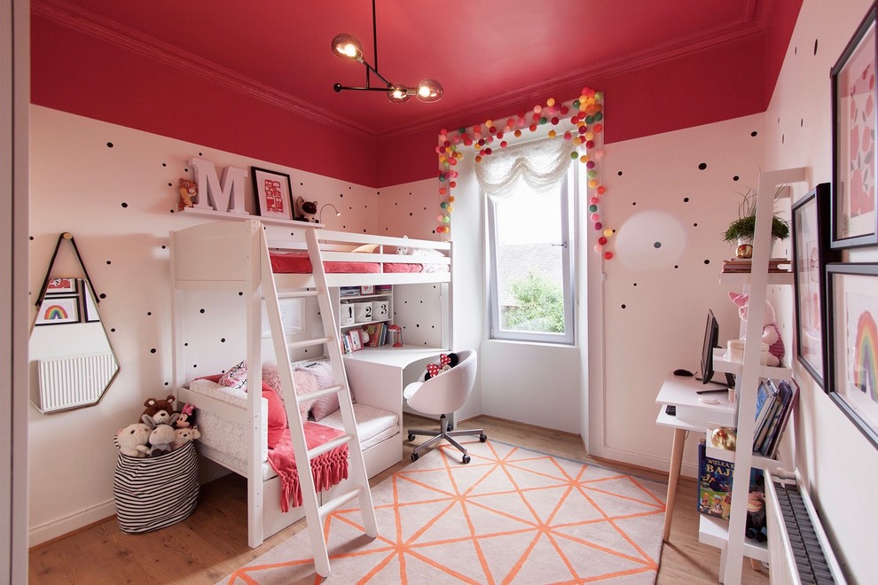 Design ideas for a mid-sized contemporary kids' bedroom for kids 4-10 years old and girls in Edinburgh with light hardwood floors and multi-coloured walls.