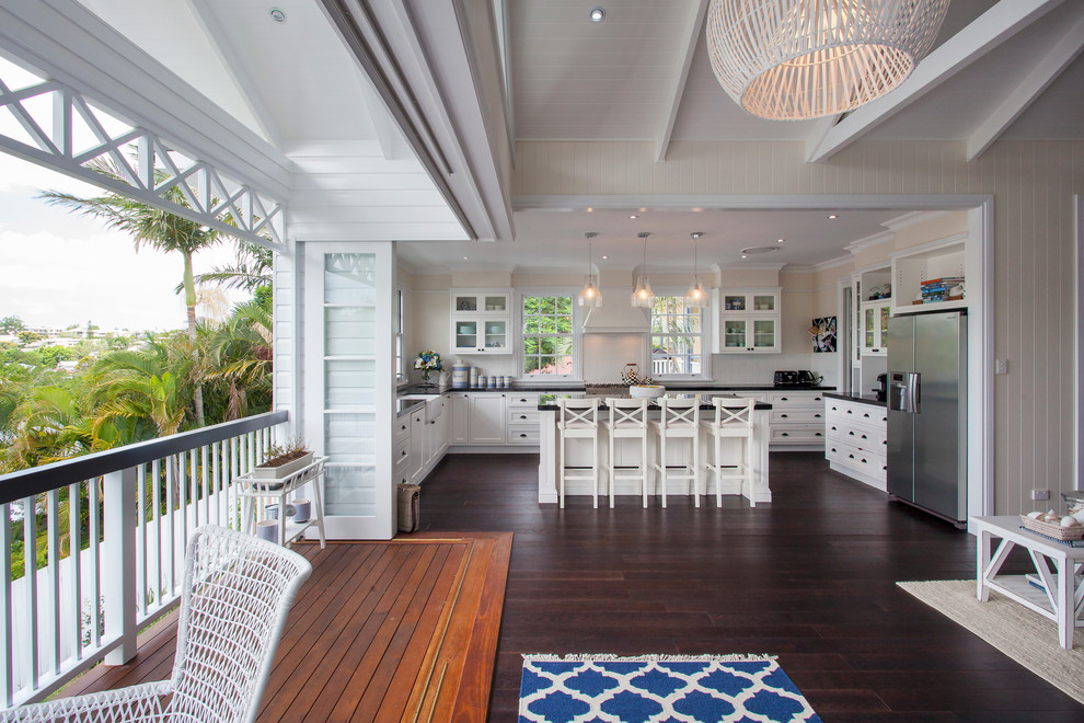 Photo of a large beach style u-shaped eat-in kitchen in Brisbane with recessed-panel cabinets, white cabinets and with island.