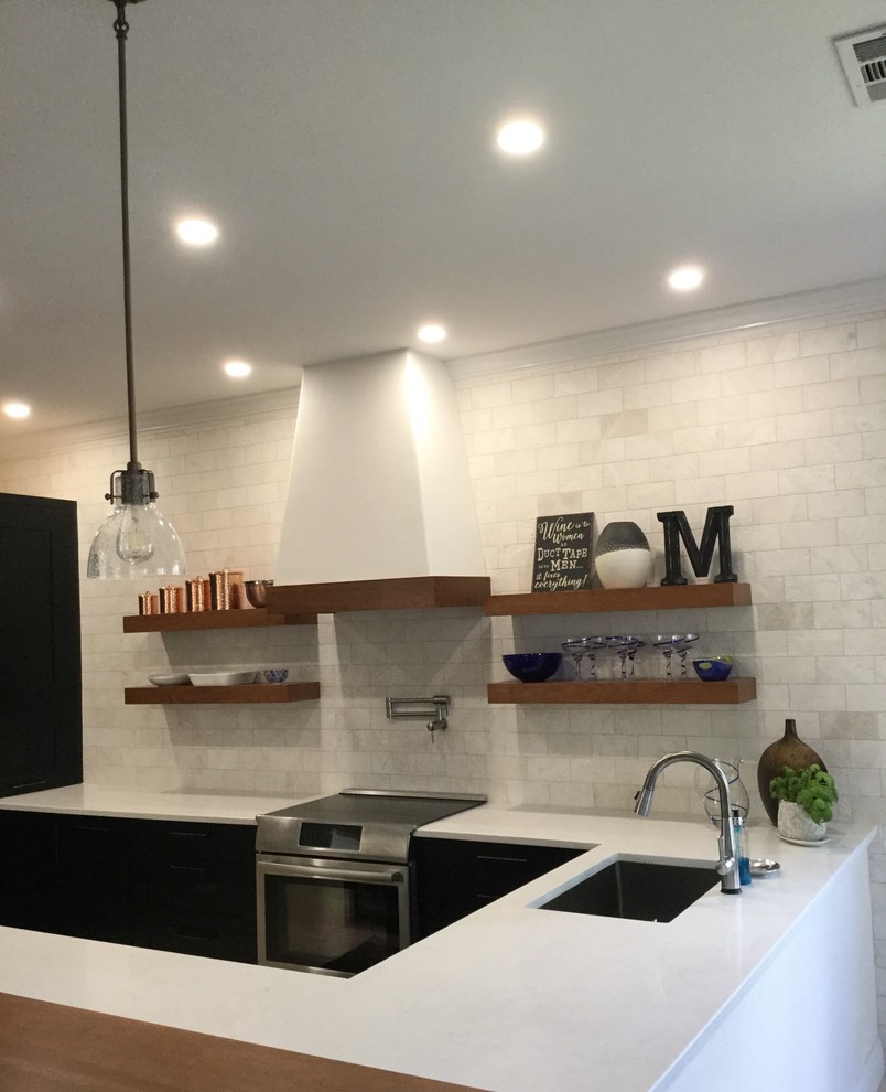 This is an example of a large transitional u-shaped kitchen pantry in Miami with shaker cabinets, dark wood cabinets, quartzite benchtops, white splashback, subway tile splashback, stainless steel appliances, with island, white benchtop and a triple-bowl sink.