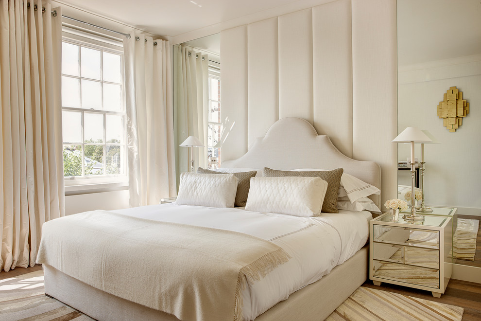 Photo of a transitional master bedroom in London with beige walls.