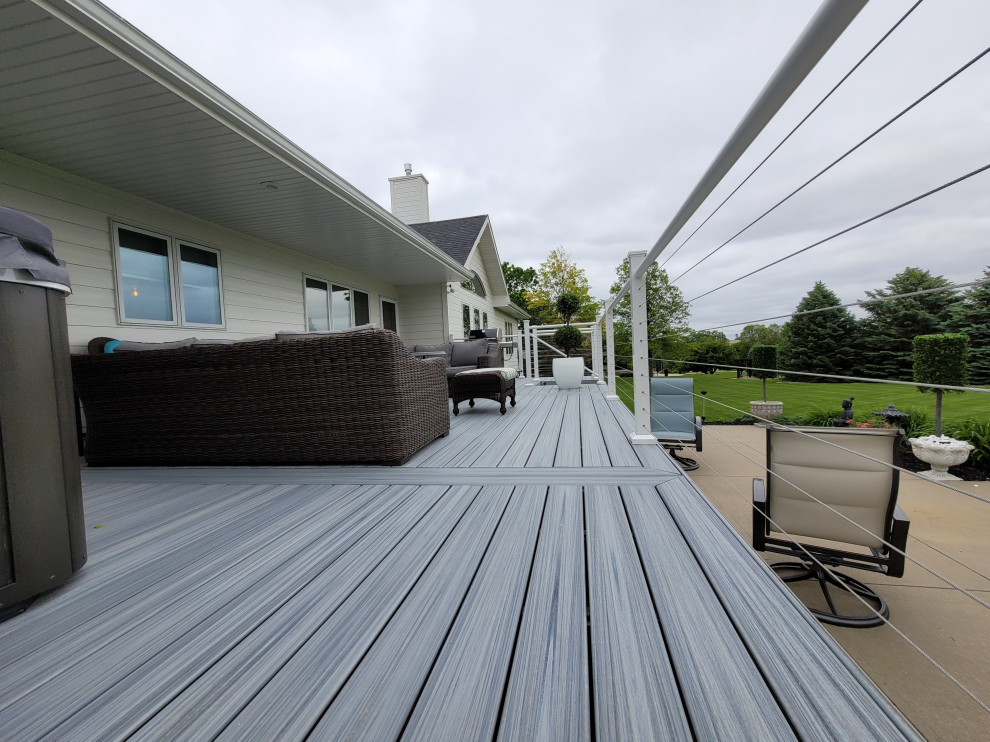 Medium sized contemporary back ground level wire cable railing terrace in Omaha.