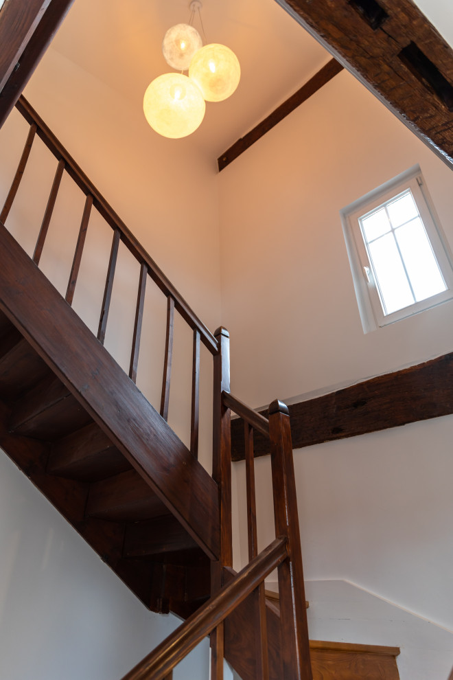 Идея дизайна: большая п-образная деревянная лестница в стиле кантри с деревянными ступенями, деревянными перилами, деревянными стенами и панелями на стенах
