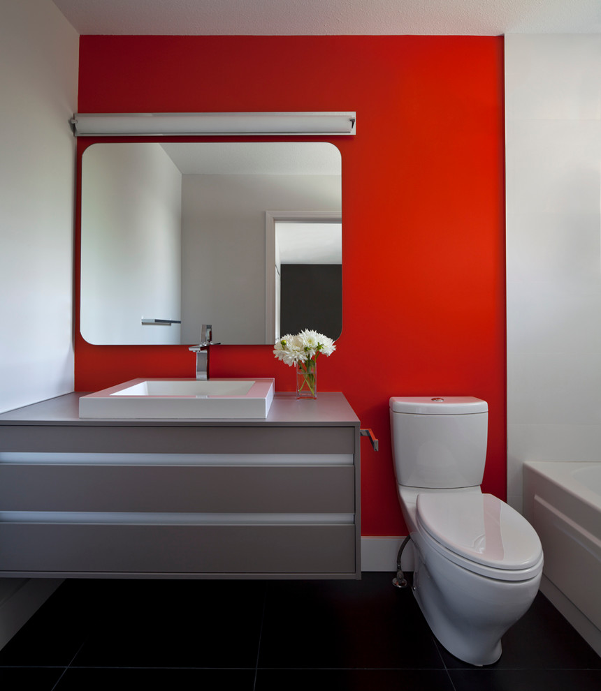 Photo of a contemporary bathroom in Vancouver with a drop-in sink and red walls.