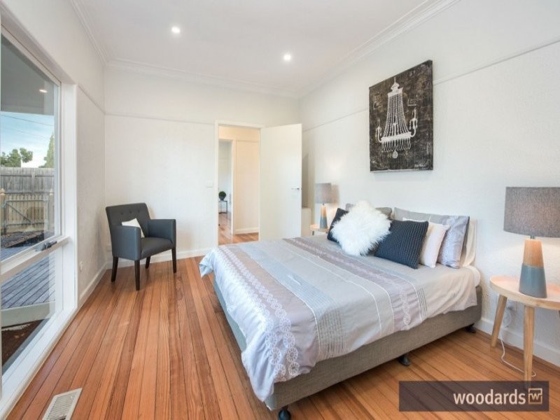 Design ideas for a mid-sized contemporary master bedroom in Melbourne with white walls and light hardwood floors.