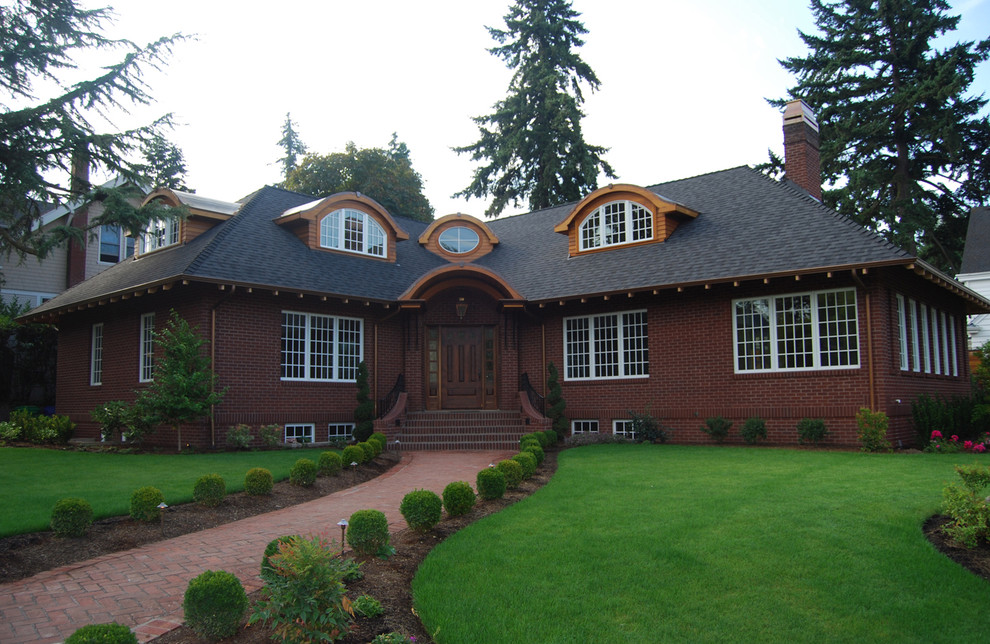 Inspiration for a large traditional three-storey brick exterior in Portland with a hip roof.