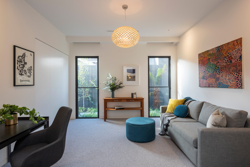 Design ideas for a contemporary enclosed family room in Melbourne with white walls, carpet and grey floor.