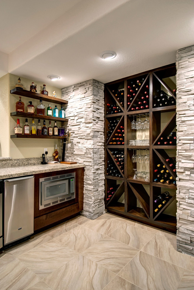 Photo of a large transitional wine cellar in Denver with beige floor and marble floors.