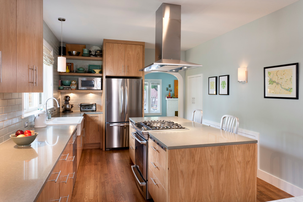 This is an example of a contemporary kitchen in Austin with subway tile splashback and stainless steel appliances.
