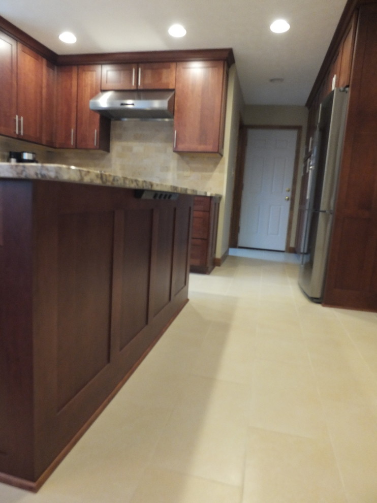 Inspiration for a mid-sized transitional l-shaped ceramic tile eat-in kitchen remodel in Columbus with an undermount sink, shaker cabinets, brown cabinets, granite countertops, beige backsplash, ceramic backsplash, stainless steel appliances and an island