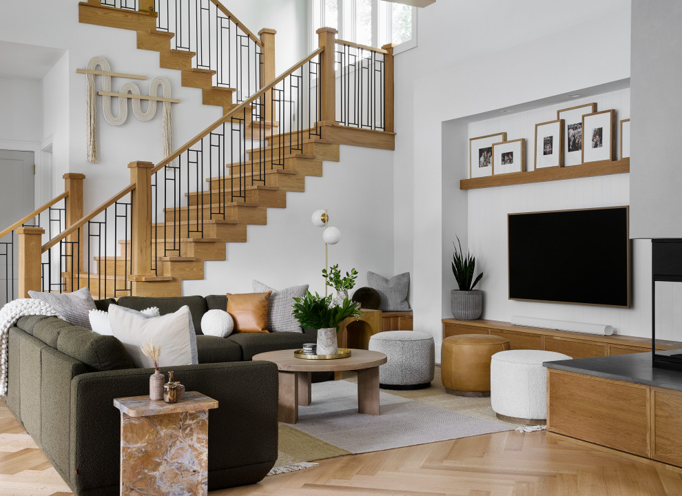 Design ideas for a large contemporary open concept living room in Chicago with white walls, light hardwood floors, a plaster fireplace surround, a wall-mounted tv, a corner fireplace and beige floor.