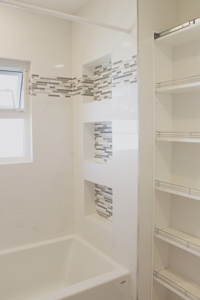 Inspiration for a mid-sized contemporary 3/4 bathroom in Other with an alcove tub, a shower/bathtub combo, white tile, ceramic tile and white walls.