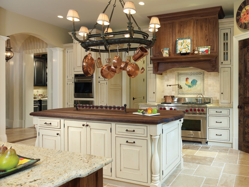 Large country galley separate kitchen in DC Metro with raised-panel cabinets, white cabinets, granite benchtops, beige splashback, stone tile splashback, a farmhouse sink, panelled appliances, travertine floors, multiple islands and beige floor.