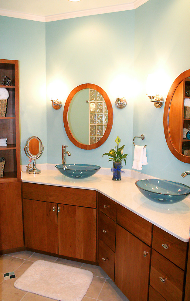 Inspiration for a traditional master bathroom in Tampa with a vessel sink, medium wood cabinets, a freestanding tub, an open shower, beige tile, blue walls and flat-panel cabinets.