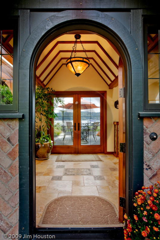 Design ideas for a mid-sized traditional front door in Seattle with yellow walls, limestone floors, a single front door, a medium wood front door and beige floor.