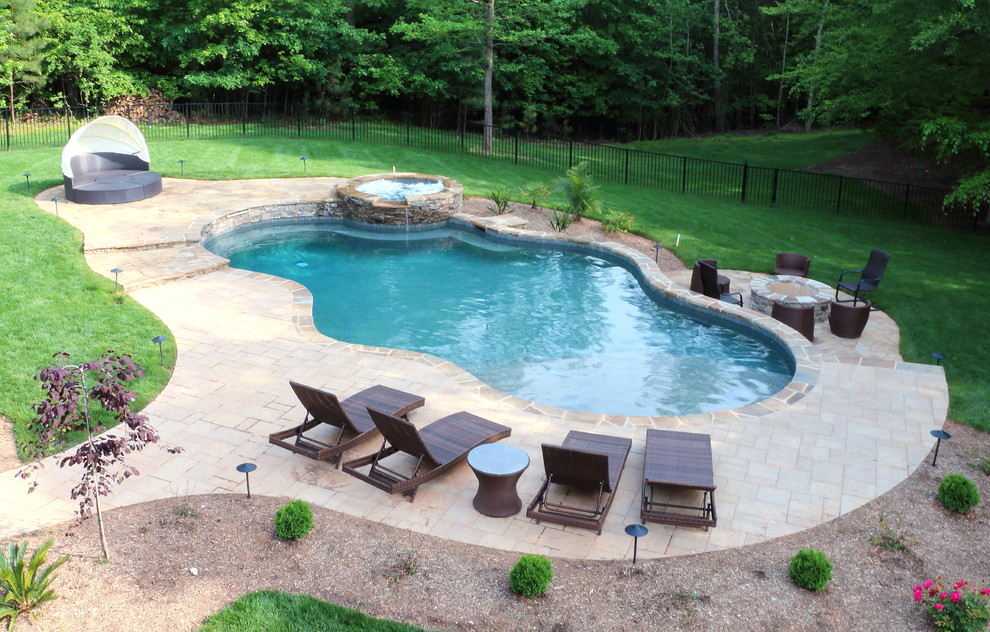Example of a mid-sized mountain style natural pool design in Raleigh