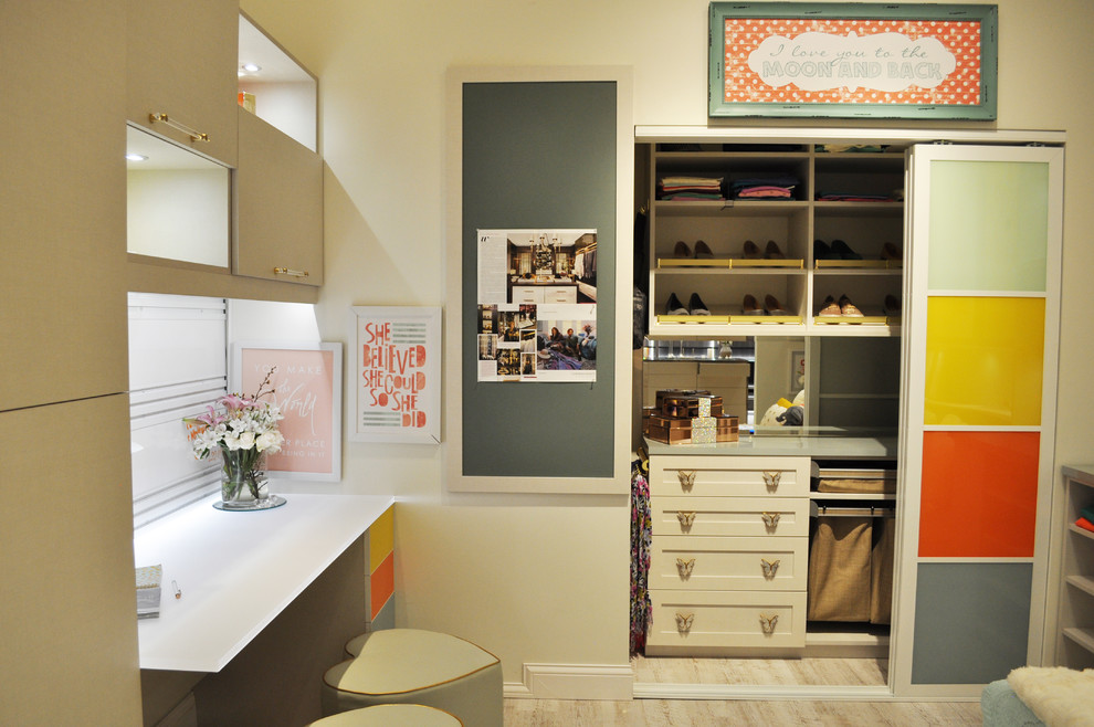 This is an example of a large eclectic gender-neutral built-in wardrobe in Minneapolis with shaker cabinets, beige cabinets and vinyl floors.