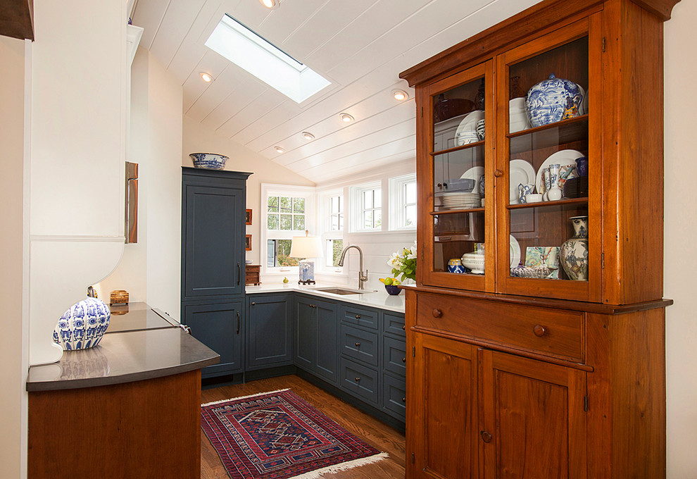 Inspiration for a small transitional galley separate kitchen in Seattle with an undermount sink, shaker cabinets, blue cabinets, quartz benchtops, white splashback, panelled appliances, medium hardwood floors and no island.