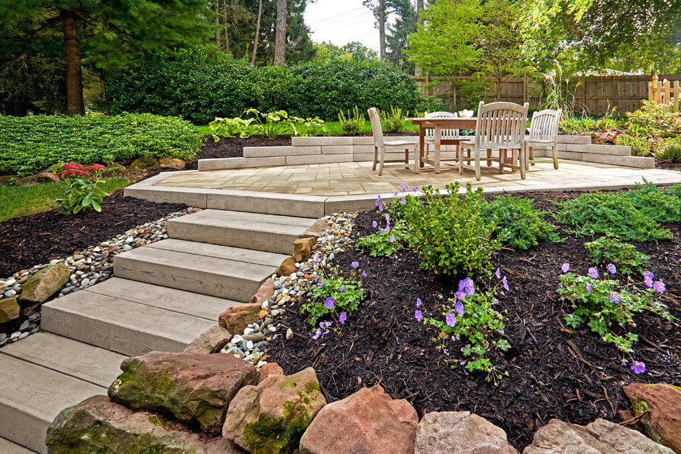 This is an example of a mid-sized rustic backyard retaining wall landscape.