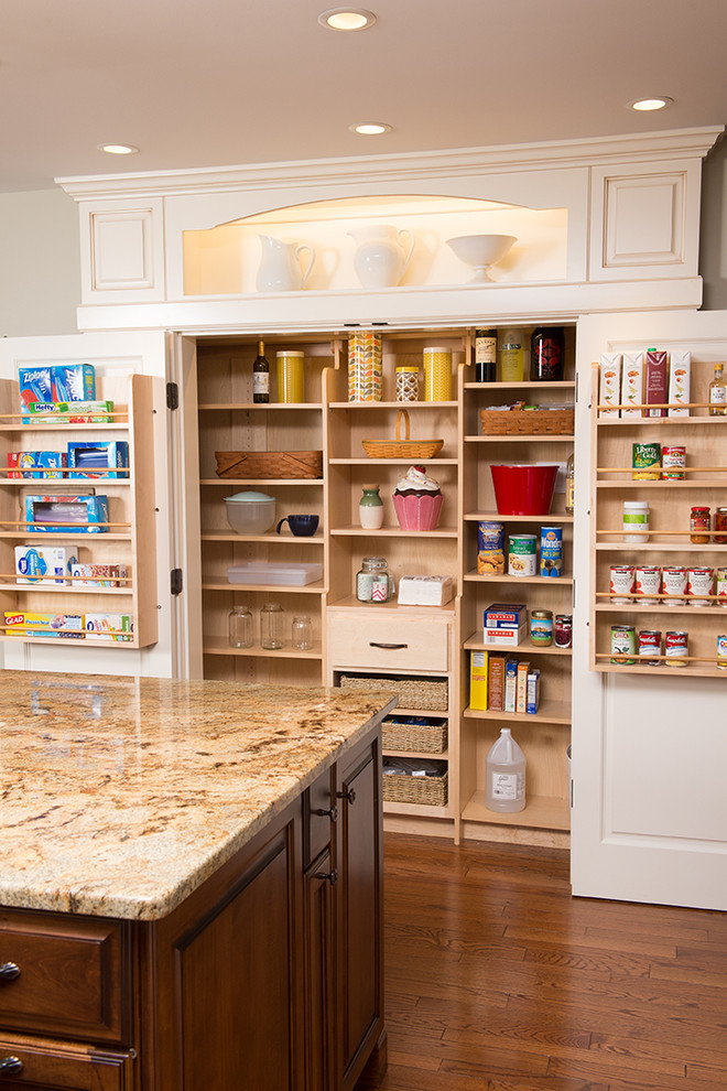 Large traditional kitchen pantry in Chicago with granite benchtops, medium hardwood floors, with island, a double-bowl sink, brown splashback, glass sheet splashback, stainless steel appliances, dark wood cabinets and open cabinets.