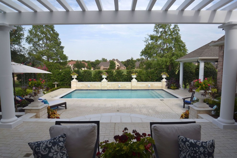Example of a mid-sized backyard rectangular pool design in Dallas