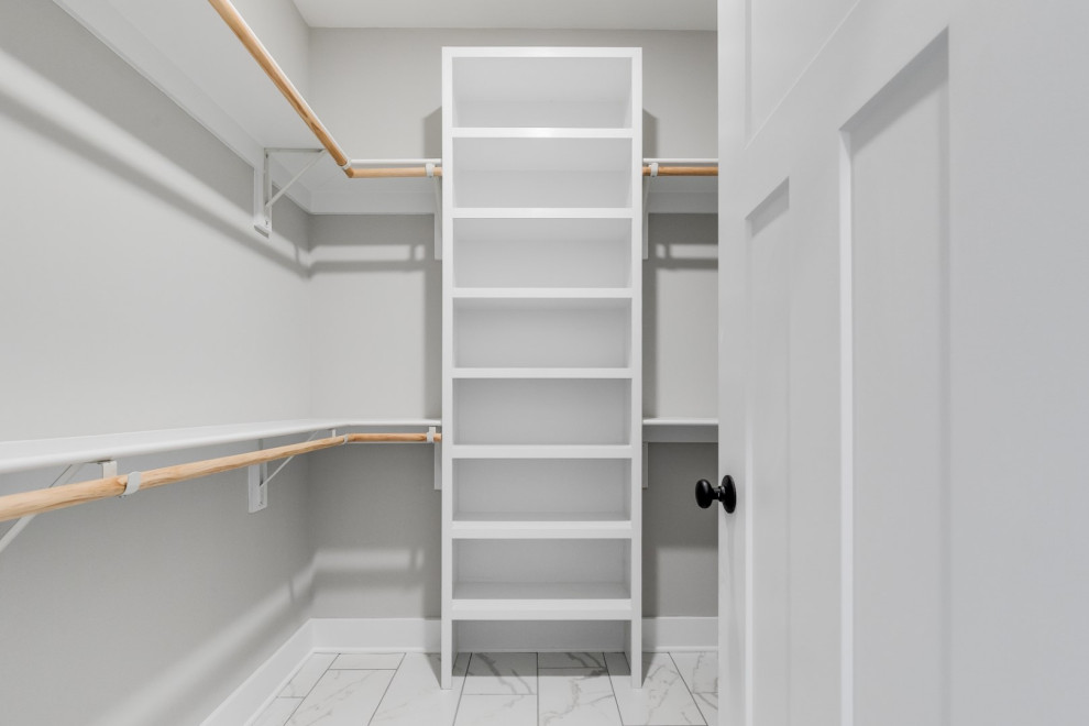 Large country gender-neutral walk-in wardrobe in Richmond with ceramic floors and white floor.