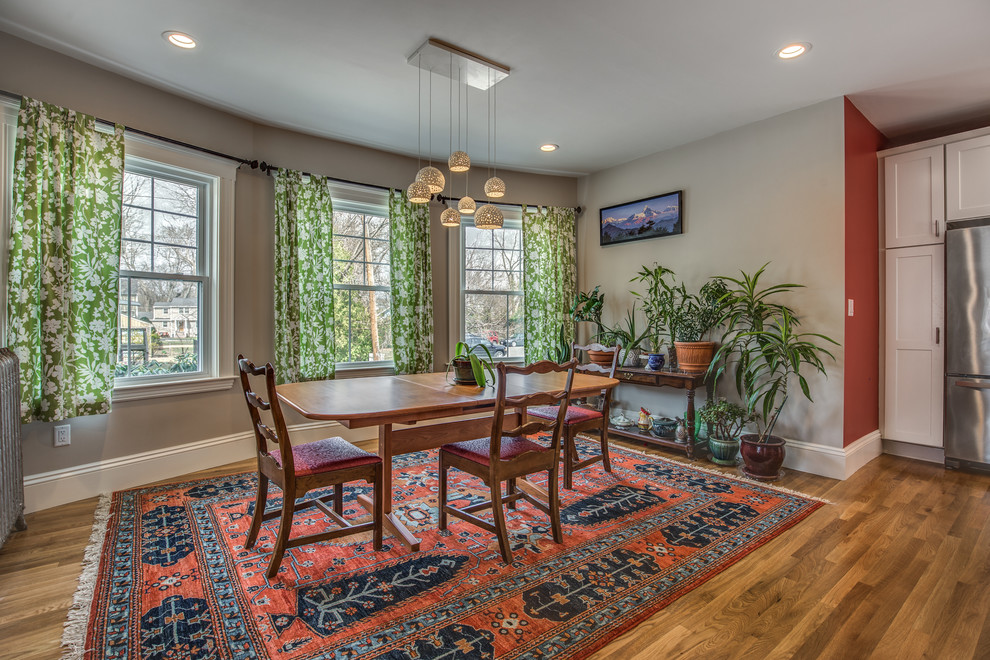 Example of a mid-sized transitional light wood floor and beige floor kitchen/dining room combo design in Boston with gray walls and no fireplace