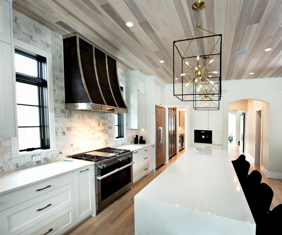 Example of a mid-sized trendy light wood floor, brown floor and wood ceiling eat-in kitchen design in Chicago with an integrated sink, shaker cabinets, white cabinets, quartz countertops, multicolored backsplash, porcelain backsplash, stainless steel appliances, an island and yellow countertops