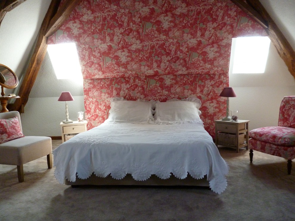 Photo of a mid-sized country loft-style bedroom in Paris with red walls, carpet and no fireplace.