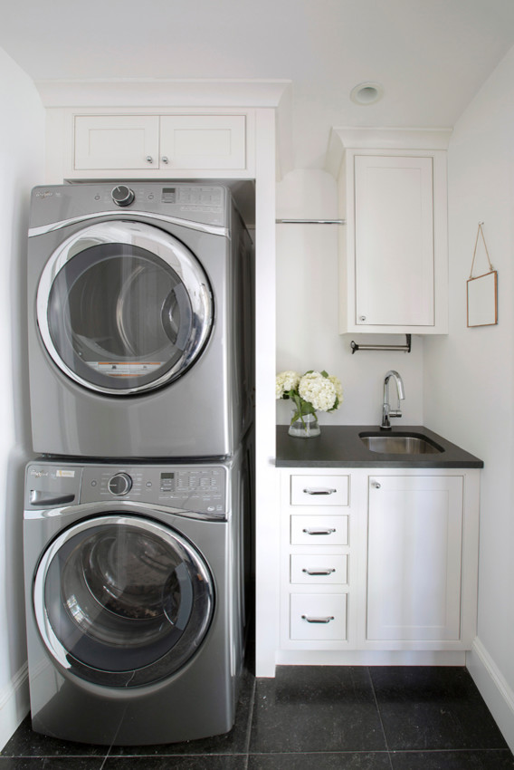 Inspiration for a mid-sized beach style l-shaped laundry room in New York with an undermount sink, shaker cabinets, white cabinets, granite benchtops, white splashback, mosaic tile splashback, painted wood floors and white floor.