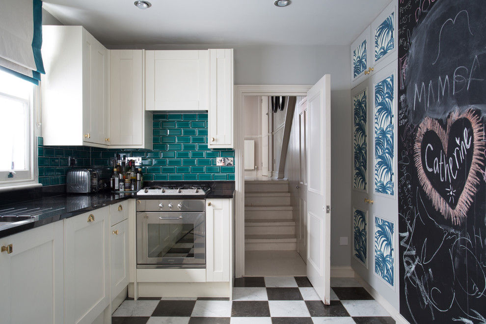 This is an example of a small contemporary kitchen in London with shaker cabinets, white cabinets and marble floors.