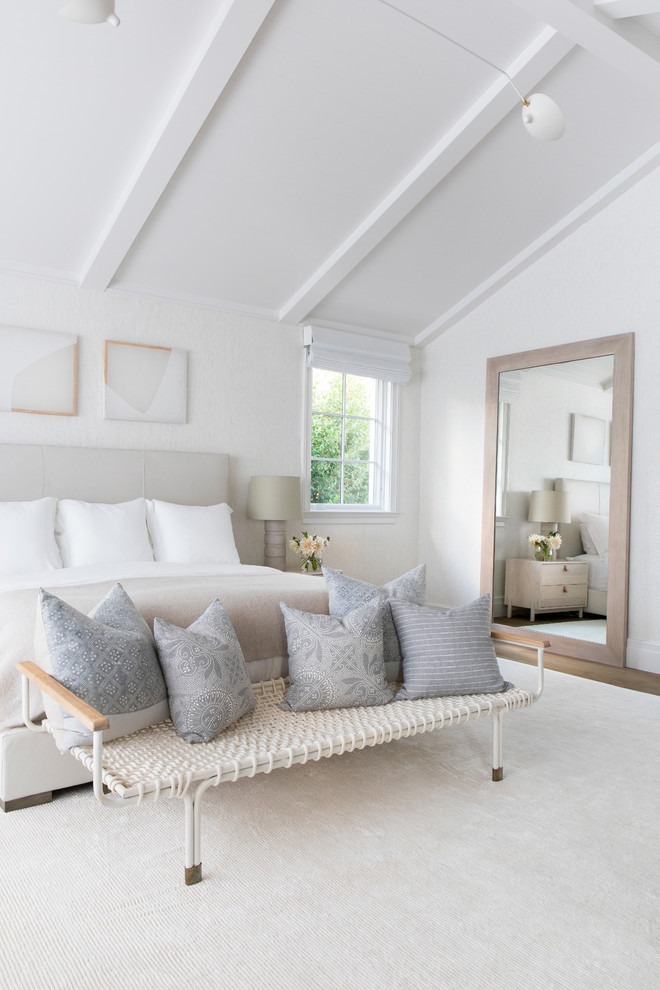 Large modern guest bedroom in New York with beige walls, light hardwood floors and beige floor.