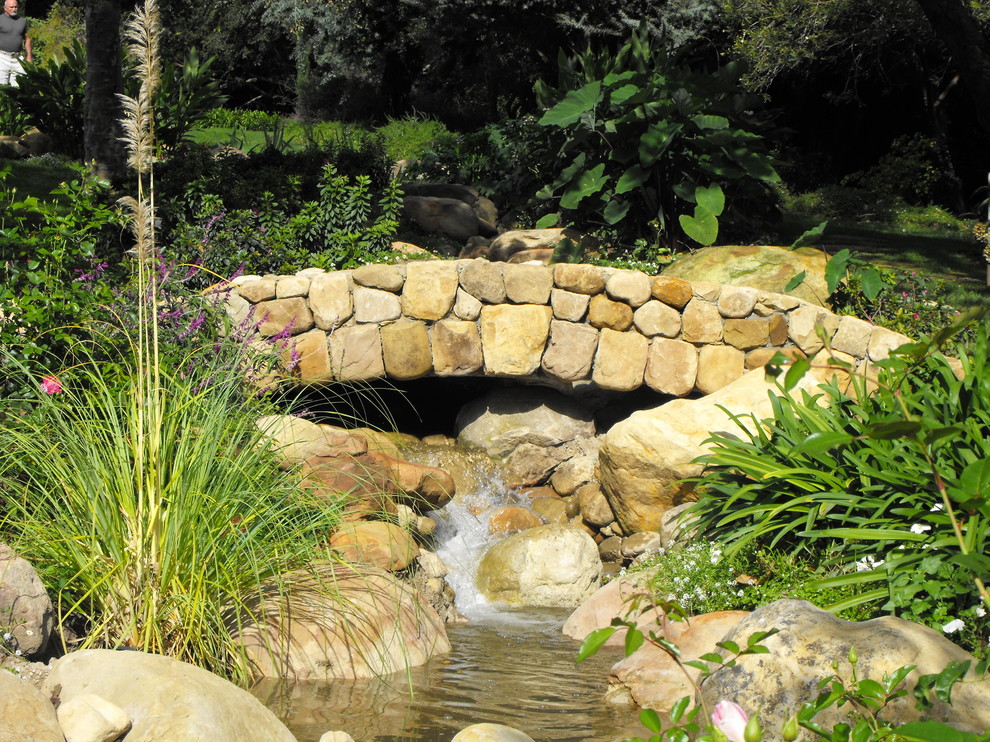 Design ideas for a large mediterranean full sun garden in Santa Barbara with a water feature.