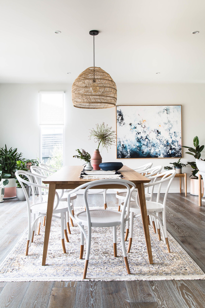 Design ideas for a scandinavian open plan dining in Melbourne with white walls, dark hardwood floors and brown floor.
