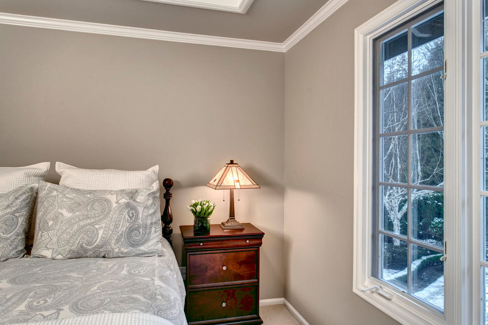 Example of a large transitional master carpeted bedroom design in Seattle with beige walls and no fireplace