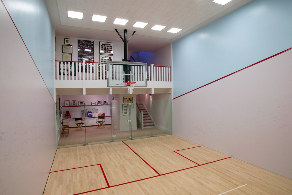 Large traditional indoor sport court in San Francisco with multi-coloured walls, light hardwood floors and beige floor.