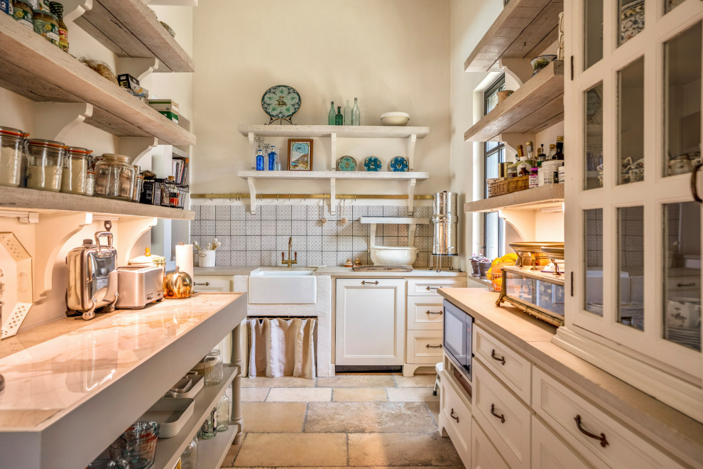 Foto di una cucina con lavello stile country, ante con riquadro incassato, ante beige, paraspruzzi grigio, elettrodomestici da incasso, nessuna isola e top beige