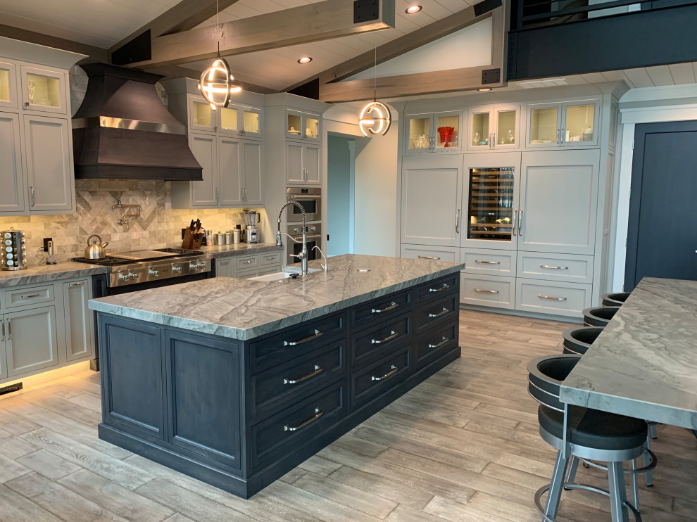 Design ideas for an expansive modern kitchen in Chicago with an undermount sink, stainless steel appliances, plywood floors, multiple islands, grey floor and grey benchtop.