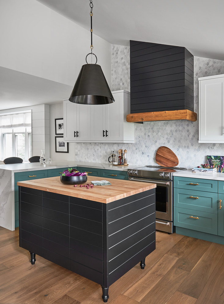 Design ideas for a country l-shaped kitchen in Toronto with a double-bowl sink, shaker cabinets, green cabinets, white splashback, mosaic tile splashback, stainless steel appliances, medium hardwood floors, with island, brown floor and white benchtop.