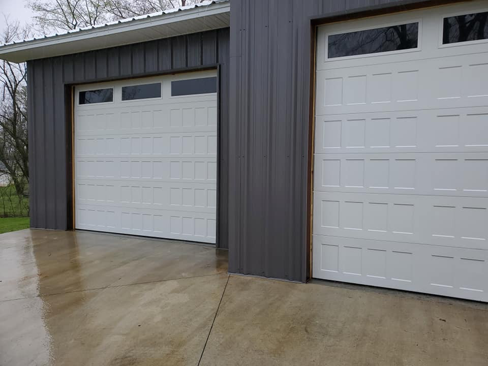 This is an example of a large traditional detached three-car garage in St Louis.