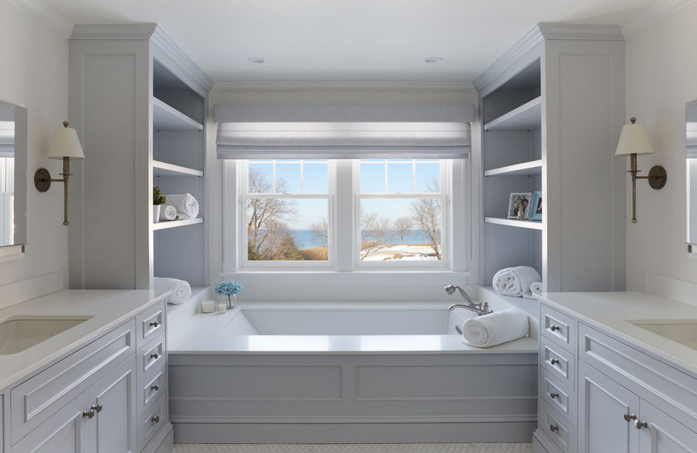 Photo of a medium sized traditional bathroom in New York with white cabinets, a corner bath, a submerged sink, engineered stone worktops, double sinks and a built in vanity unit.