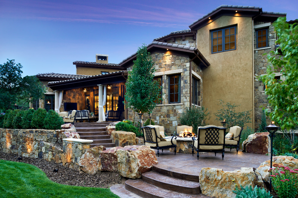 Example of a mid-sized trendy backyard stone patio design in Denver with a pergola and a bbq area