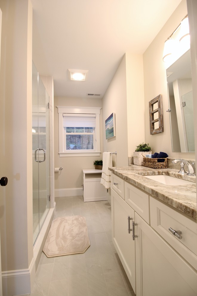 Alcove shower - mid-sized transitional kids' porcelain tile and beige floor alcove shower idea in Boston with recessed-panel cabinets, white cabinets, a two-piece toilet, beige walls, an undermount sink, quartz countertops, a hinged shower door and brown countertops