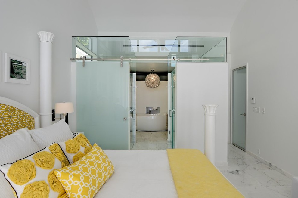 This is an example of a contemporary bedroom in Miami with white walls.
